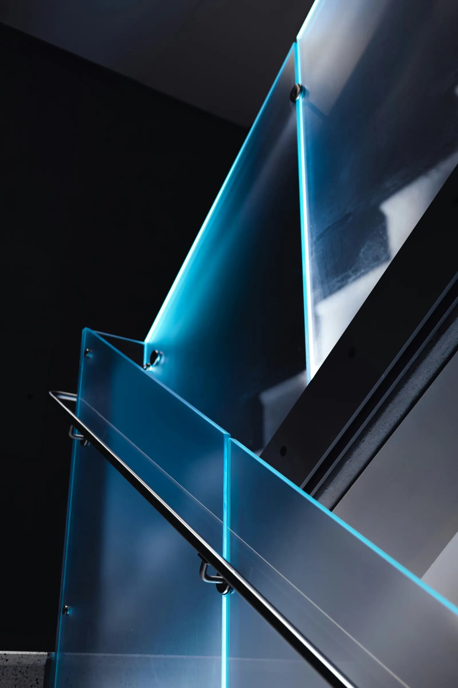 Blue illuminated architectural glass staircase